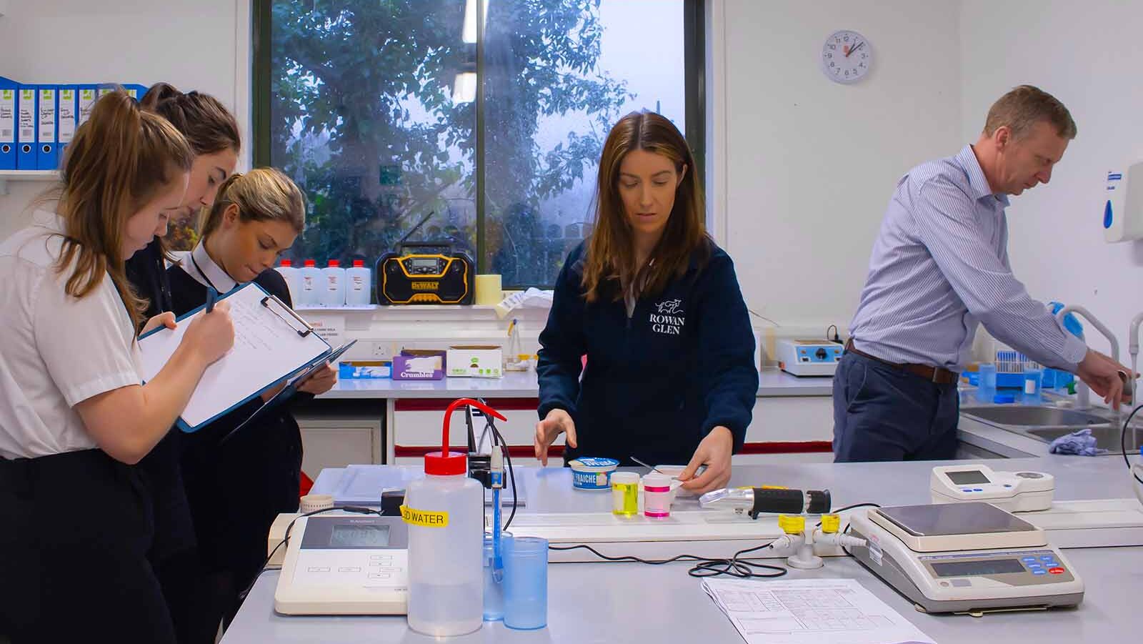 Stranraer Academy students: Brooke, Pippa, and Aoifa at Rowan Glen's facility testing yogurts and taking notes as part of their SVQ Apprenticeship in Food and Drink Technologies.